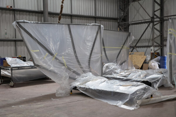 Component parts of steel canopy wrapped ready for transportation