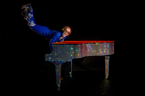 Photo of Elton John model against black background