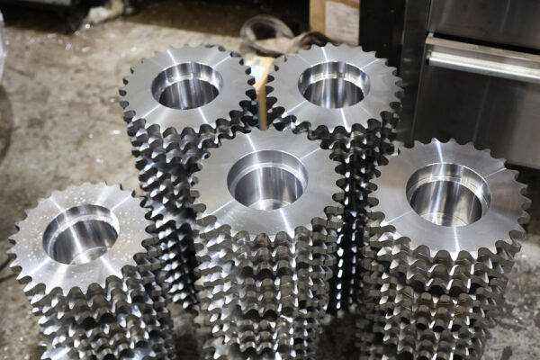 Photo of stacks of machined sprocket components
