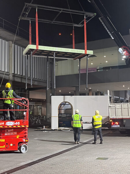 Photo of installing exhibition structures during night shift