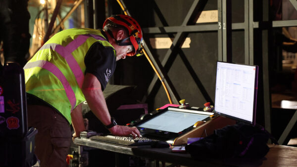 Photo of staff member at show control console