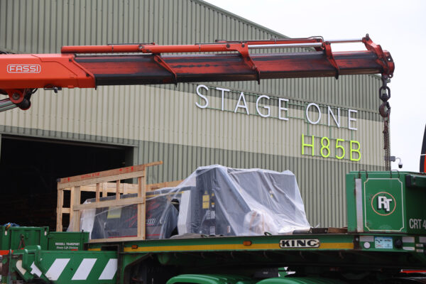 Photo of laser plate cutting machine on flatbed truck ready to be lifted by crane