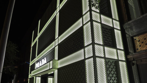 Photo of Prada's takeover of Harrods store front in London, fretwork being installed overnight