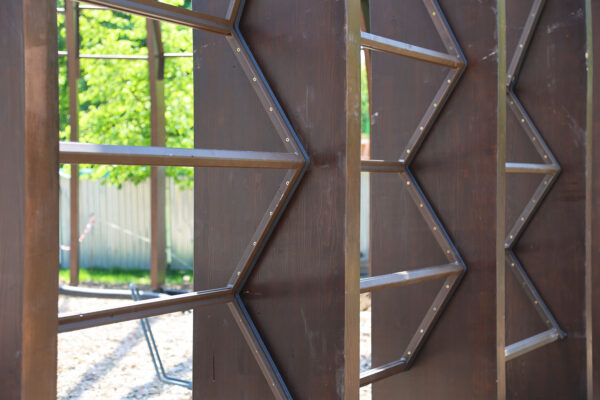 Photo of metal frame structures fitted between timber beams