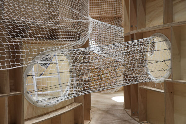 Photo of net football tunnel connecting two plywood structures