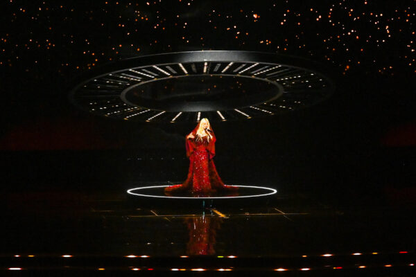 Photo of Christina Aguilera singing on stage at Joy Awards 2025 with light ring above