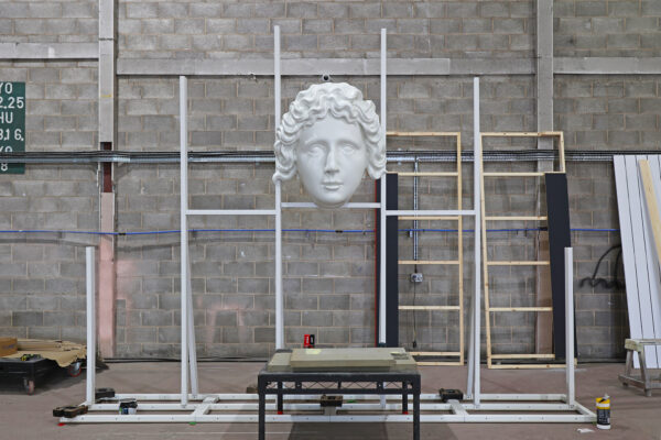 Photo of face sculpture mounted upon a steel frame