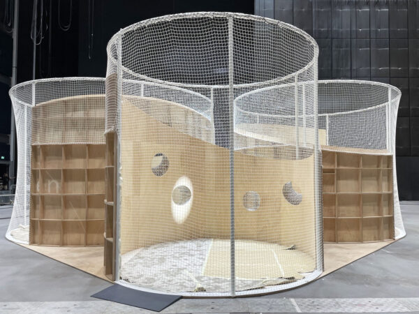 Photo of a trio of circular pod structures with net covering