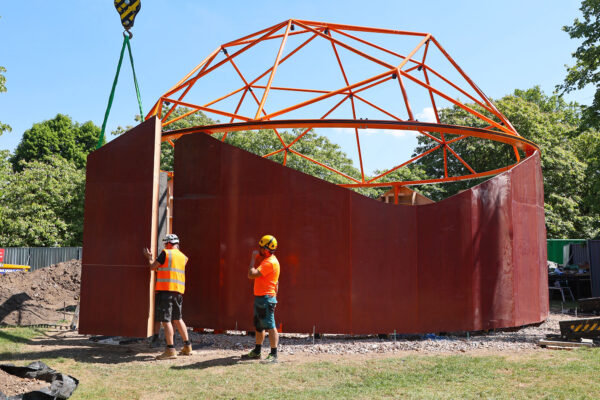 Phot of Play Pavilion during build, wall sections lifted by crane