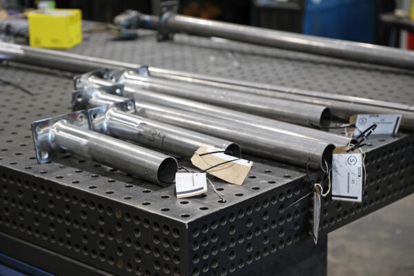 Photo of steel poles laid on workbench