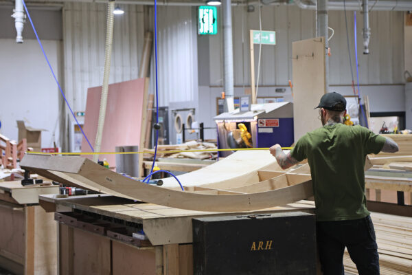 Photo of woodworker measuring timber structure