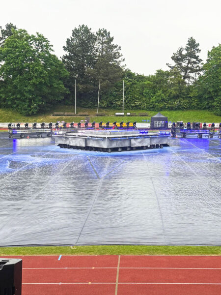 Photo of stage being installed on football pitch