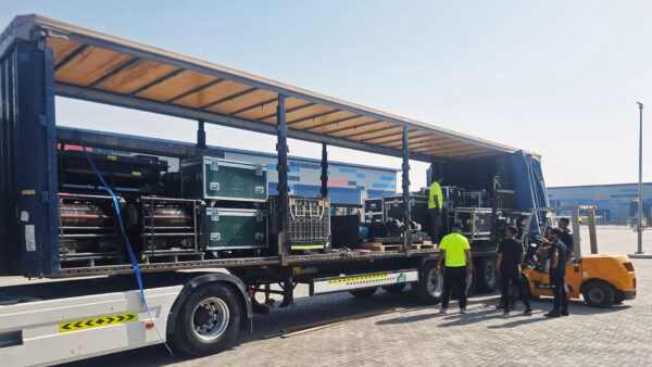 Photo of large truck stocked with equipment being unloaded