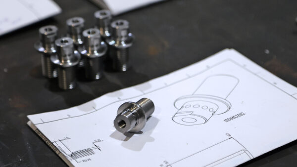 Photo of metal component with corresponding CAD drawing