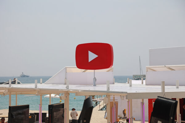 Photo of YouTube icon structure mounted on a roof canopy in a beach location