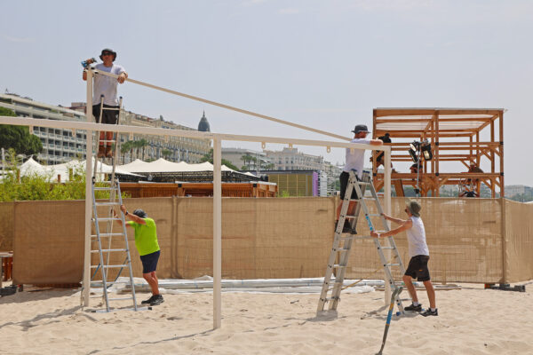 Photo of team building a steel structure in a beach location