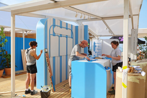 Photo of team painting a set display