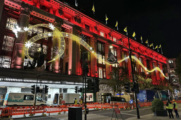 Photo of illuminated store facade at Selfridges, London during installation at night