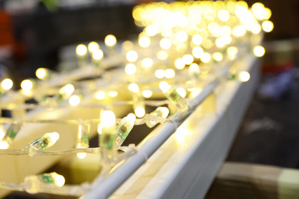Close up photo of fairy lights wrapped around a steel frame