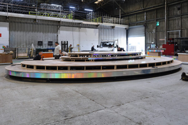 Test build of tiered oval stage in warehouse space